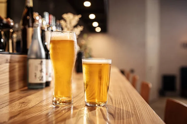 Two glasses of japanese light beer on a bar desk — Stock Photo, Image