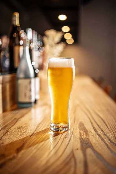 Glass of japanese light beer on a bar desk — Stock Photo, Image