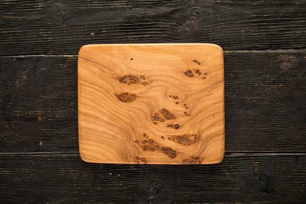 Wooden board mock up on a dark wooden background — Stock Photo, Image