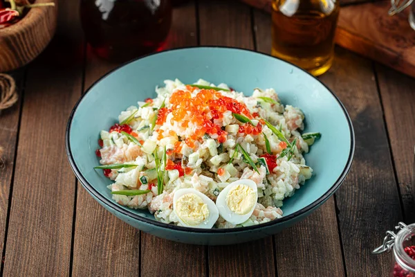 Russian olivier salad with salmon and caviar — Stock Photo, Image