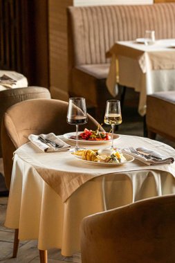 Sofrası olan şık bir restoran, yumuşak doğal ışık ve yumuşak gölgeler sıcak yemek atmosferi yaratıyor.