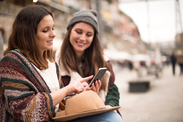 Amici con uno smartphone in strada — Foto Stock