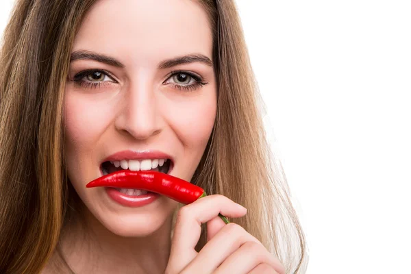 Woman eating pepper Stock Picture