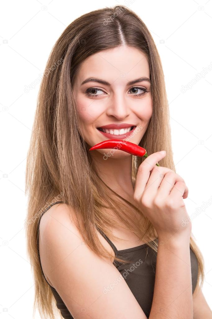 Woman eating pepper