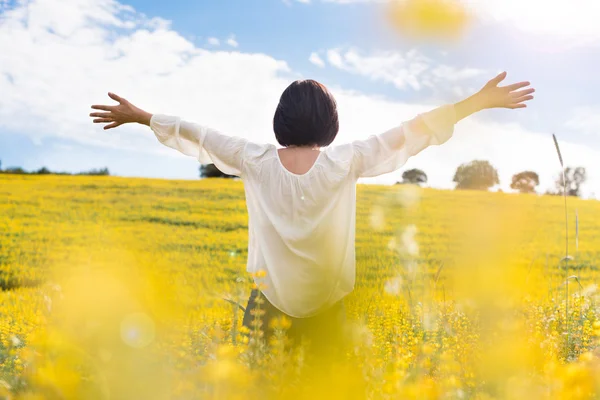 Woman in yellow field — Stock Photo, Image