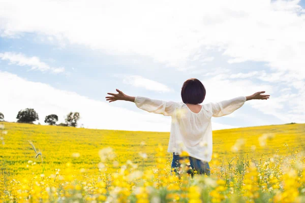 Woman in yellow field — Stock Photo, Image