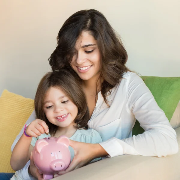 Mom and daughter saving money — Stock Photo, Image