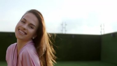 Sabahları karizmatik gülümseyen kadın çatı katındaki temiz havanın tadını çıkarıyor. Çok heyecanlı. ARRI Alexa 'da çekim