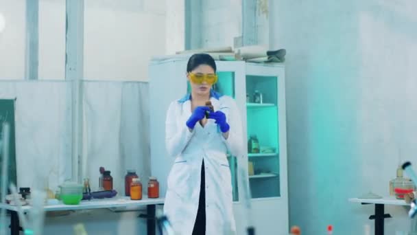 In front of the camera concept of biotechnology pharmaceutical industry lady scientist very attractive working concentrated on a project using test glass tubes — Stock Video