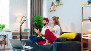 Happy charismatic couple make a live stream for social media account they have a conversation and capturing video using a light ring