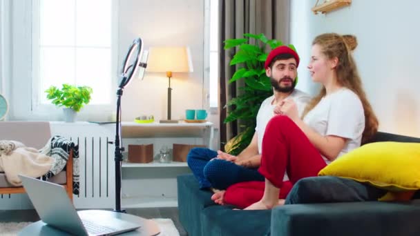 Happy and excited couple make live stream social media account using a light ring they dancing and singing on the sofa in living room — Stockvideo