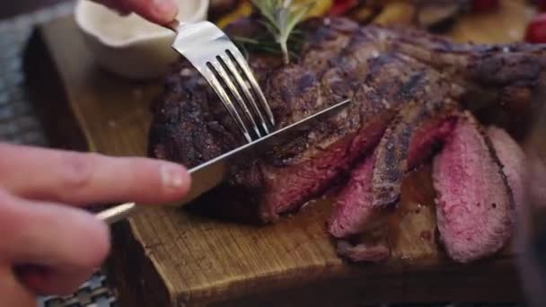 매우 즙 이 많은 쇠고기 스테이크를 한 남자 가 레스토랑에서 주문하는 모습 — 비디오