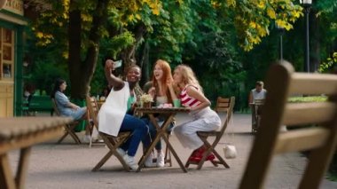 Kafe 'de bir grup güzel, çekici bayanın çok ırklı buluşması ve kahvelerini içerken anılarının fotoğraflarını çekmeleri için selfie zamanı. ARRI Alexa Mini 'de çekilen.