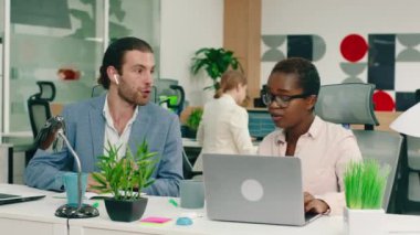 Çok çekici iki işçi çalışma masalarında çok parlak bir ofiste derin bir sohbet içindeler. Menajerleri onlara yaklaşıyor.