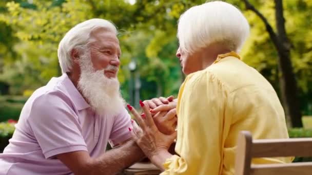 Very charismatic and lovely old couple have a romantic time at cafe discussing with passion together and holding hands. Shot on ARRI Alexa Mini. — Stock Video