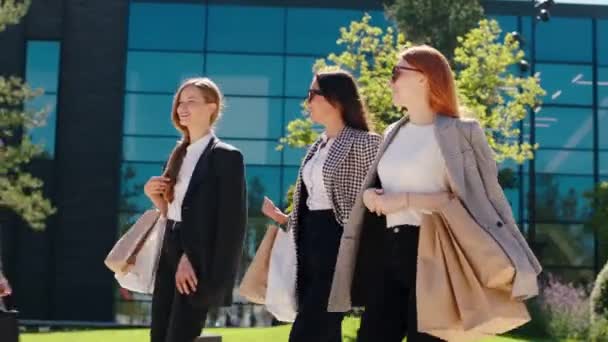 Atrakcyjne kobiety biznesu po dobrych zakupach szczęśliwy i podekscytowany spaceru przed kamerą przez nowoczesne miasto z nowoczesną architekturą budynku. Arri Alexa Mini Przewodniczący. — Wideo stockowe