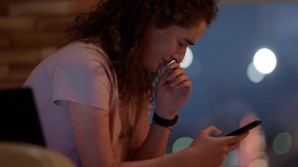 No humor deprimido difícil jovem mulher sentada no sofá e tentando trabalhar em seu laptop e smartphone ao mesmo tempo — Vídeo de Stock