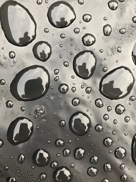 Gotas de agua en la superficie negra. Gotas de agua macro. —  Fotos de Stock