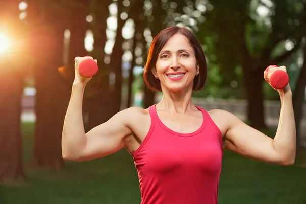 Perempuan berolahraga dengan dumbbells — Stok Foto