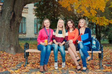 female students sitting on bench