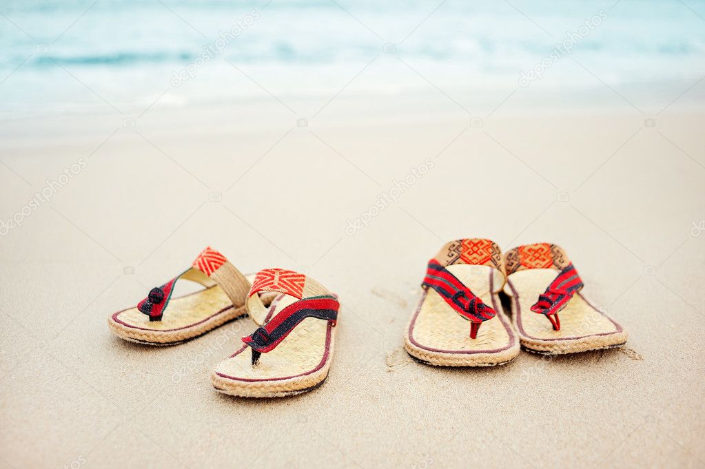 Flip flops on a sandy beach.