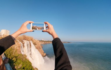 Woman taking photo of Duden waterfall clipart