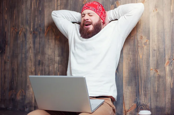 Bearded man working on laptop