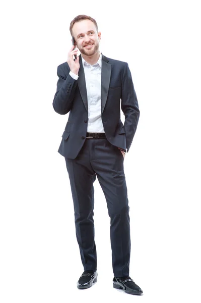 Hombre joven en traje usando teléfono inteligente — Foto de Stock