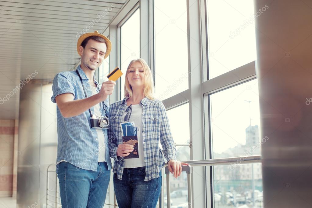 Dreaming couple holding credit card.