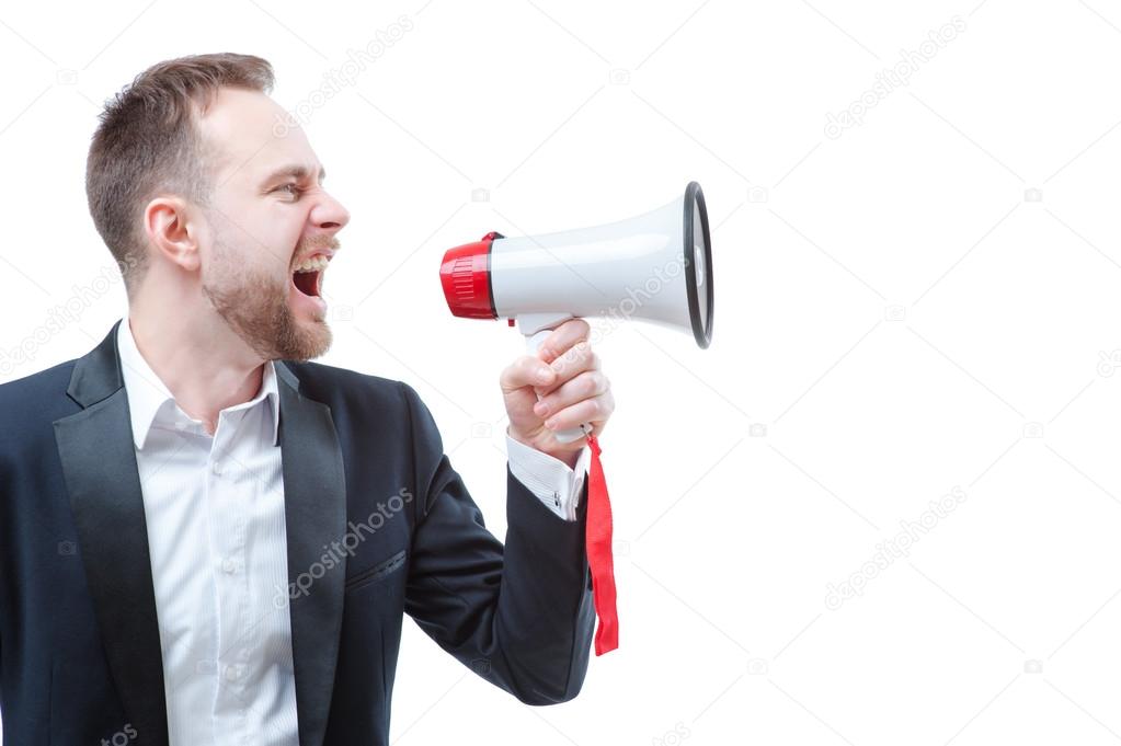 Young businessman using megaphone.