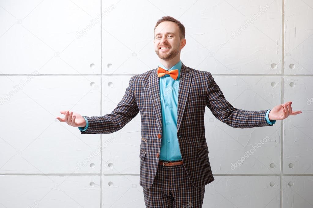 Cheerful young man in plaid suit