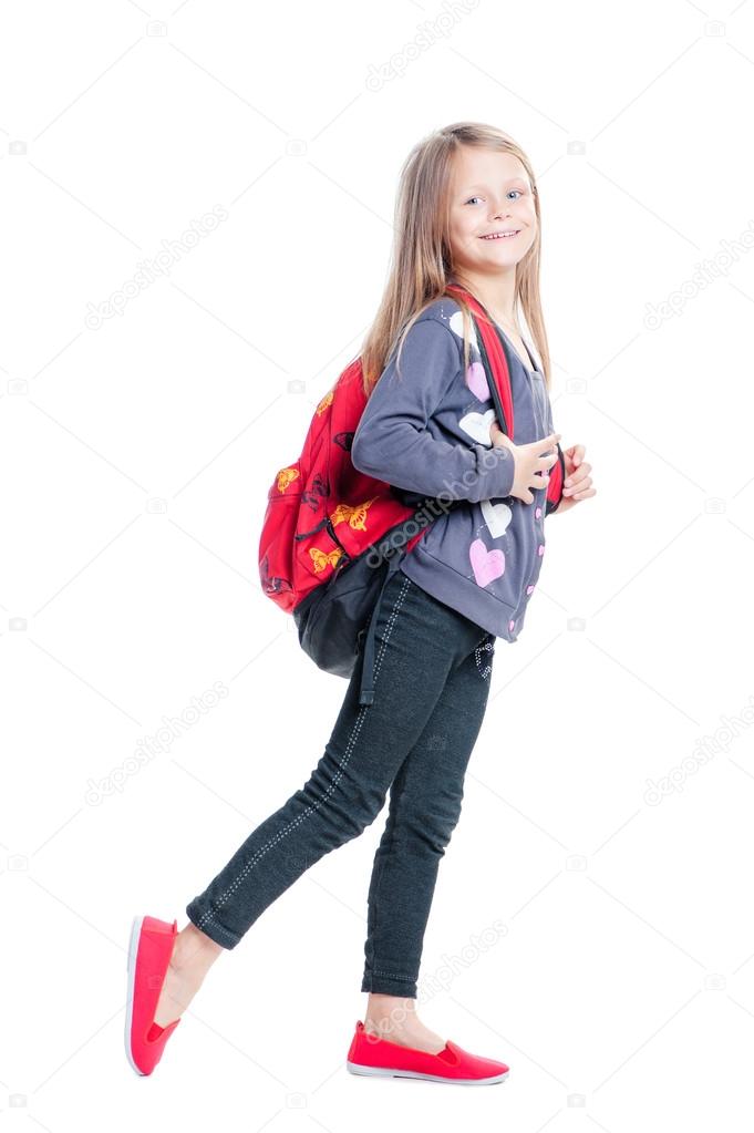 Little girl walking with backpack Stock Photo by luengo ua