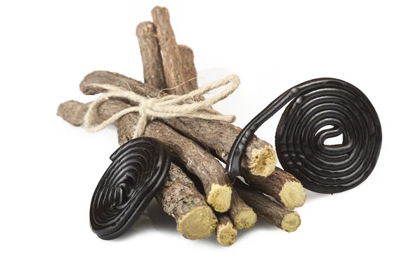 Liqorice roots and candies — Stock Photo, Image