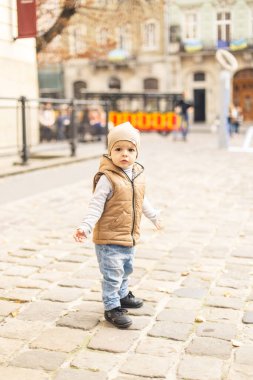 a little boy walking alone in the old town