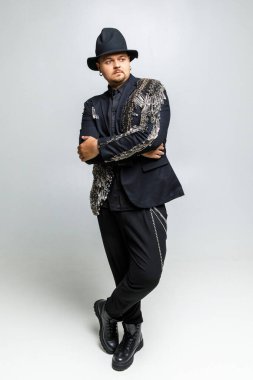 Beyaz arka planda siyah elbiseli vahşi bir adamın portresi.