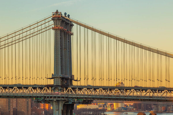 NEW YORK, USA - MARCH 9, 2020: View of Manhattan bridge from Brooklyn bridge in afternoon light.