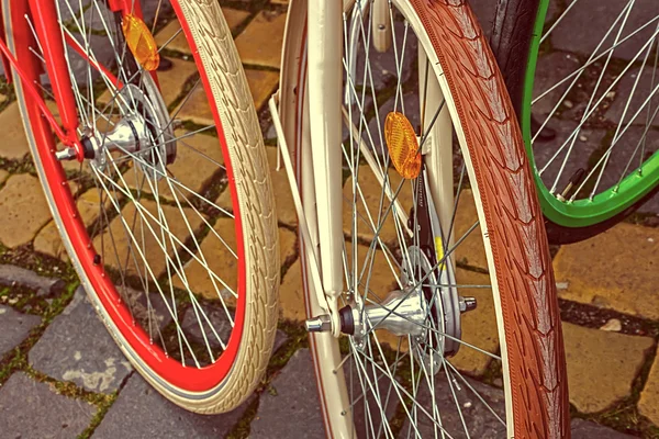 Vintage look at multicolored bicycle wheels — Stock Photo, Image