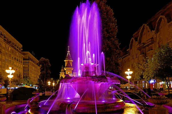 Purple illuminated fountain on the Plaza Opera in Timisoara — Stock Photo, Image