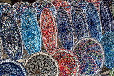 Background with Tunisian traditional ceramic in the plates form, painted with specific patterns.