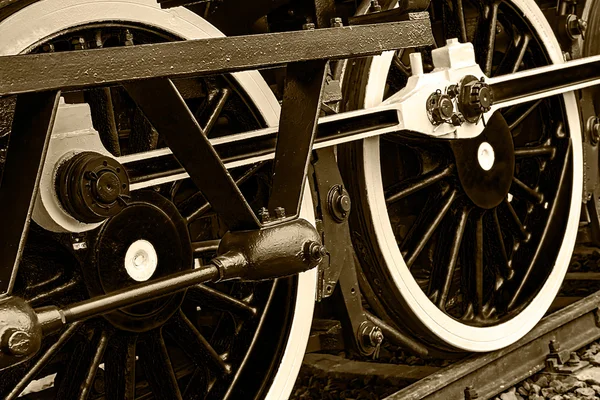 Sepia detail and close up of huge wheels at one old steam locomo — Stock Photo, Image