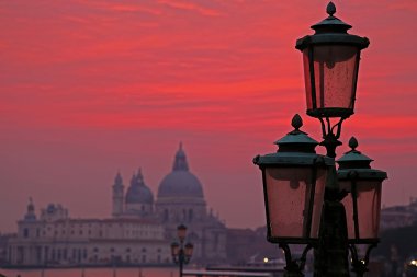 Sunset red and lanterns lit street in Venice, Italy clipart