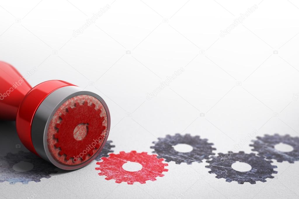 Rubber stamp over paper background with black gears symbol printed on it plus one red cog wheel. Concept image for collaboration or teamwork illustration.