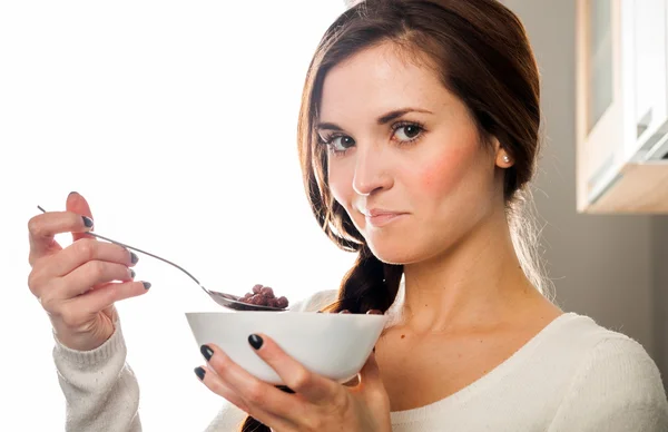 Woman with bowl of coco cereal, homemade breakfast — Stock Photo, Image