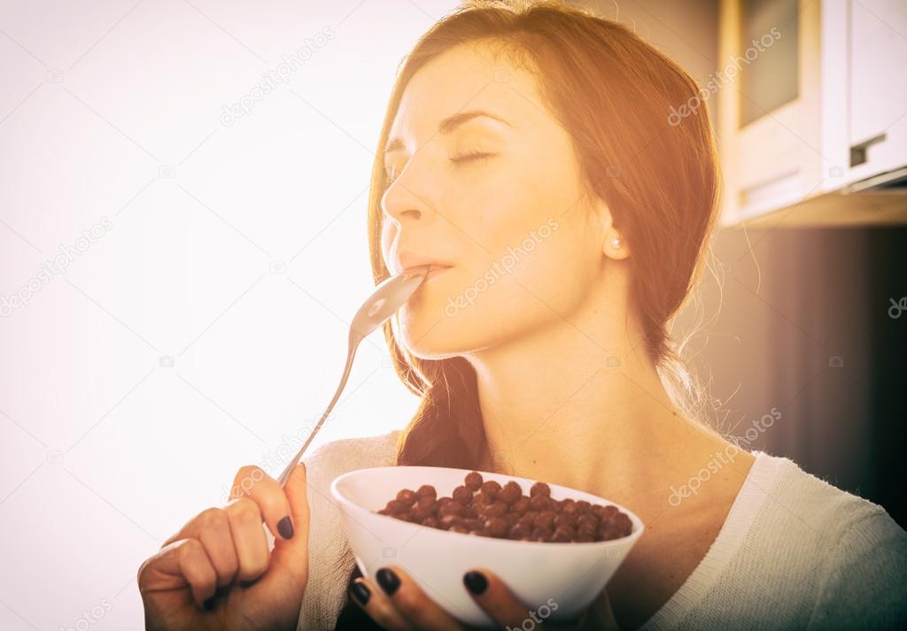 Woman with bowl of coco cereal, homemade breakfast