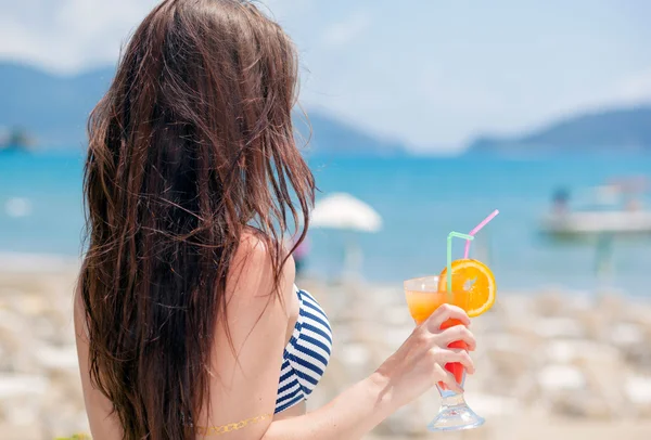 熱帯の休暇中にビーチでカクテルを持つ女性 — ストック写真