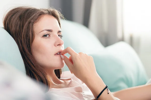 Young woman lying on couch and thinking about something at home — Stock Photo, Image