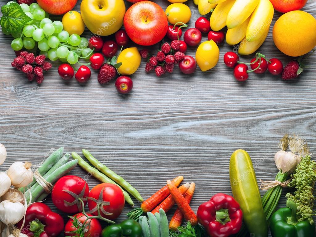 Mixed fruits and vegetables on wooden board, concept of healthy eating