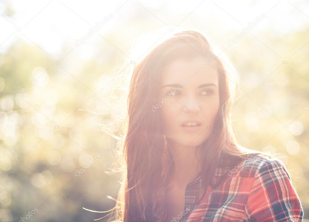 Young woman outdoor portrait, soft sunny daylight