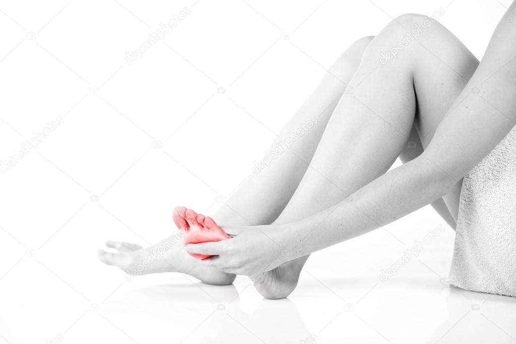 Woman massaging her aching foot, female problem