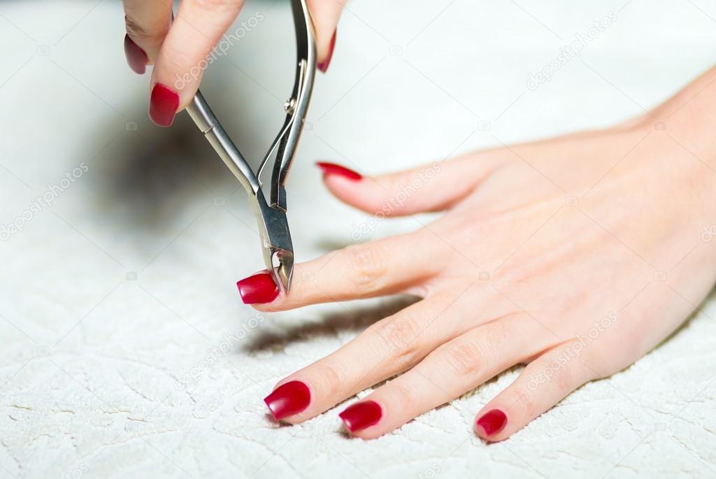 Woman hand manicure trimming cuticles